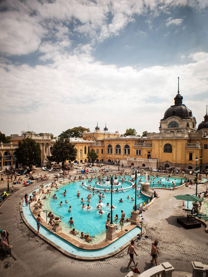 A Large Pool With People In It Wallpaper