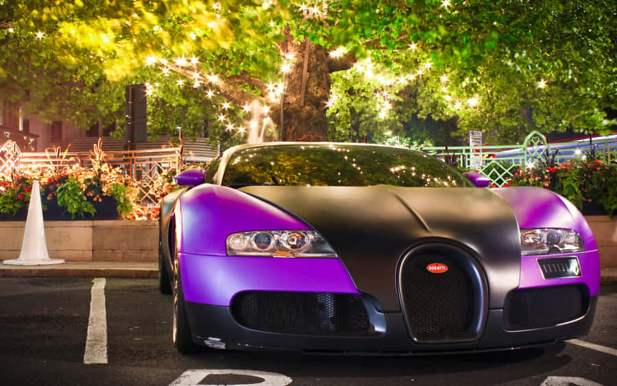 A Luminous Bugatti Illuminated In The Night Sky Wallpaper