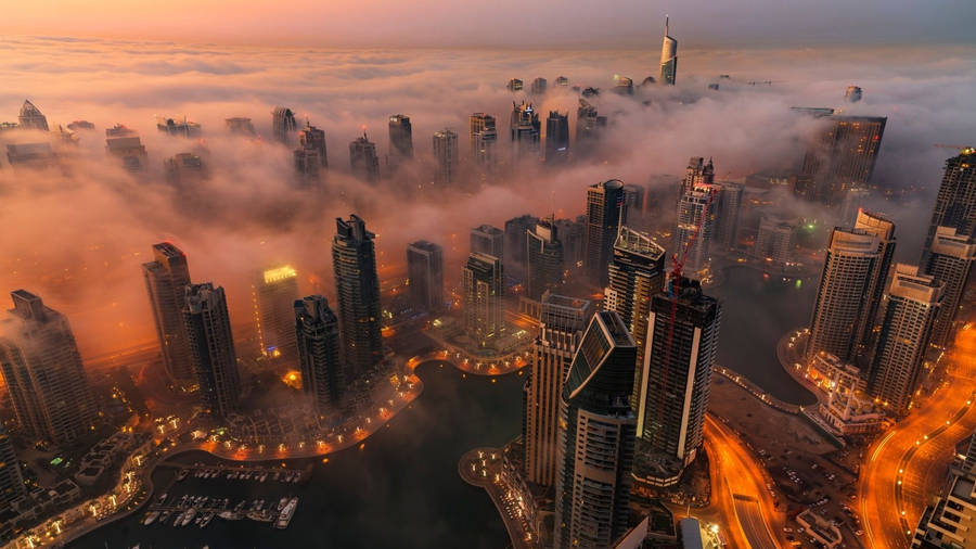 A Majestic View Of A Foggy Dubai City Wallpaper