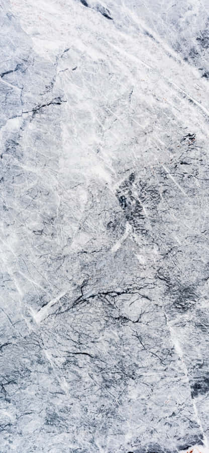 A Man Is Riding A Snowboard On A Snowy Surface Wallpaper