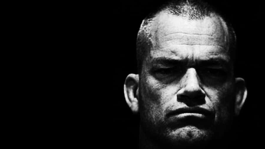 A Man Is Staring At The Camera In Black And White Wallpaper