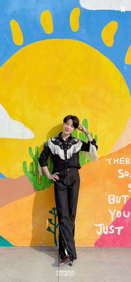 A Man Standing In Front Of A Colorful Wall Wallpaper