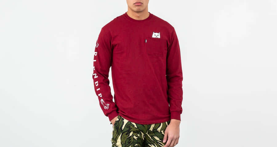 A Man Wearing A Red Long Sleeve Shirt And Camo Pants Wallpaper