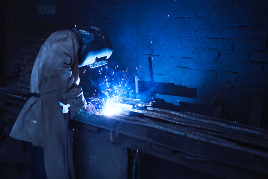 A Man Welding Metal Wallpaper