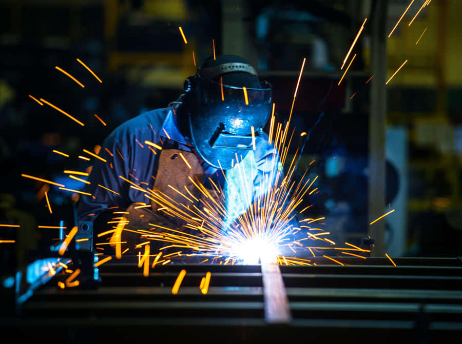 A Man Welding Metal Wallpaper