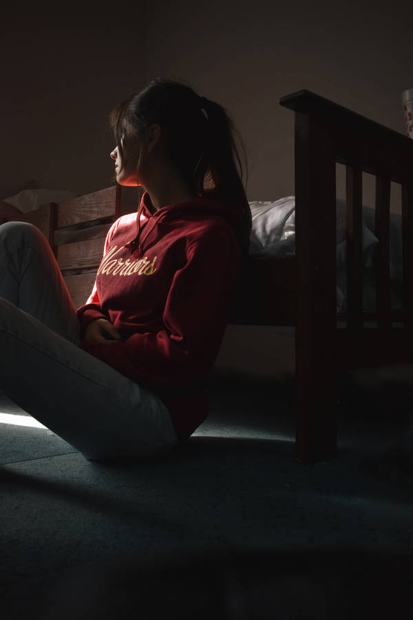 A Melancholic Solitude: Woman In Her Bedroom Reflecting On Her Emotions. Wallpaper