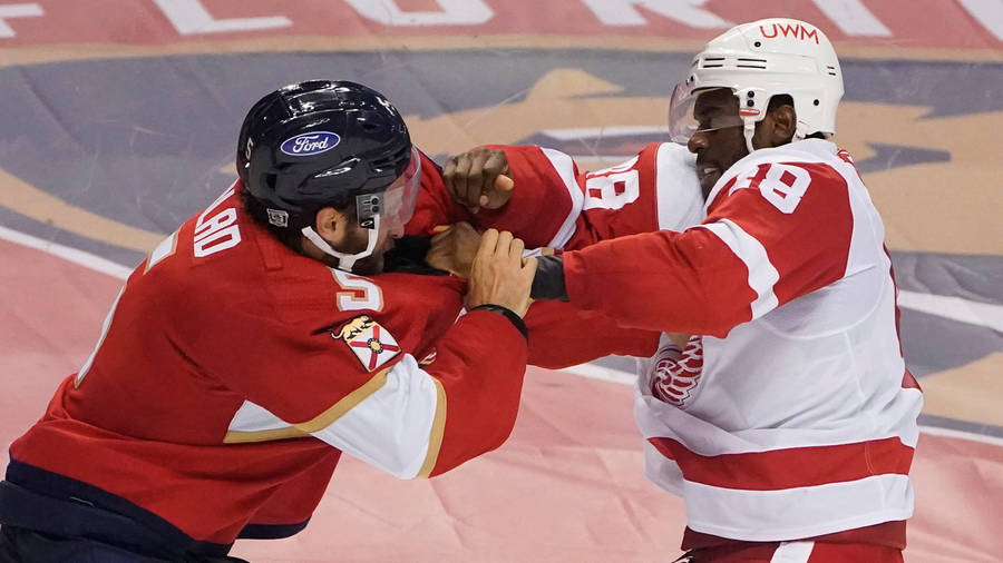 A Mighty Clash On Ice: Aaron Ekblad Versus Givani Smith Wallpaper