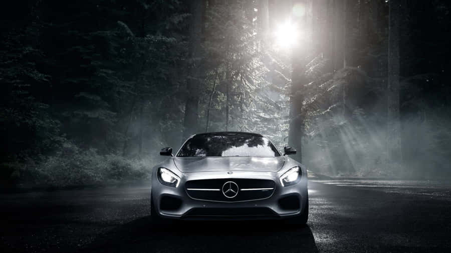 A Modern-day Sedan Car In A City Landscape Wallpaper