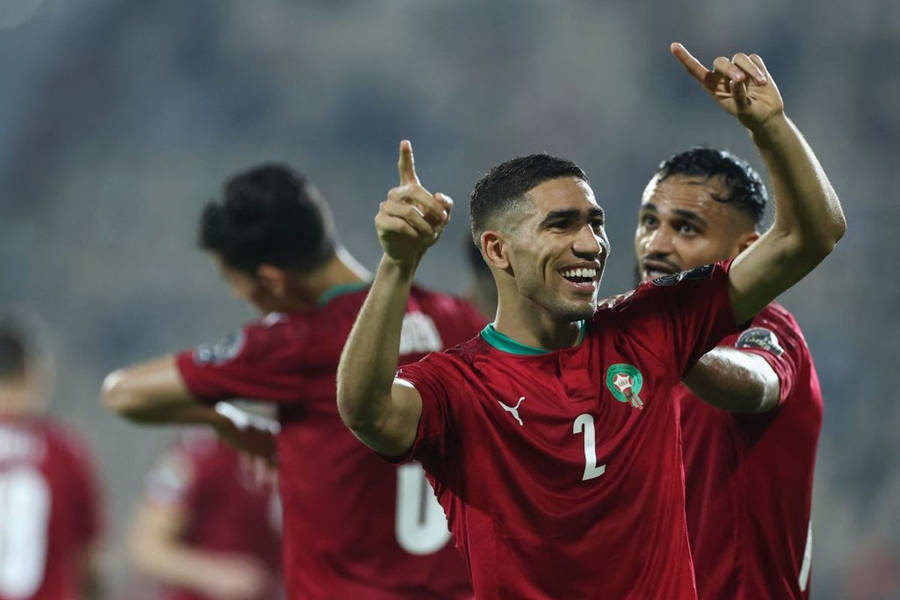 A Moroccan National Football Team Player Celebrating With A Point Towards The Sky Wallpaper