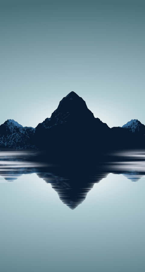 A Mountain Range Is Reflected In The Water Wallpaper