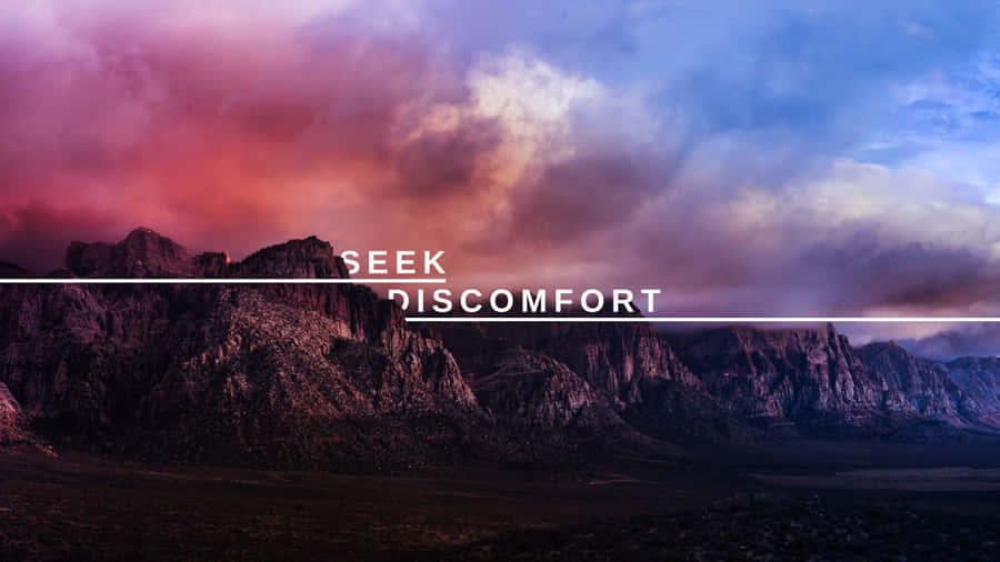 A Mountain Range With The Words Seek Discomfort Wallpaper