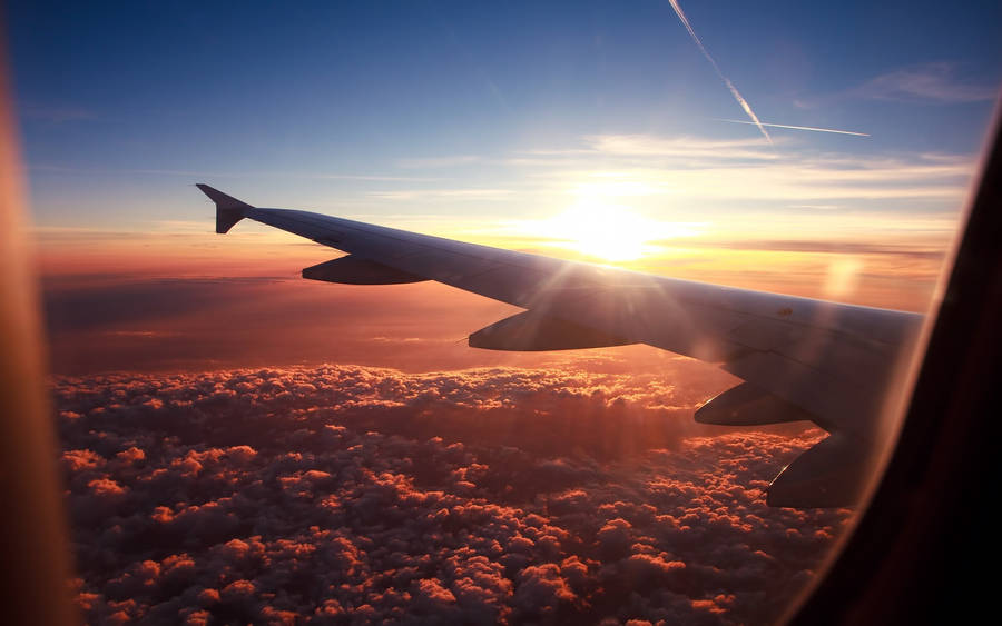 A Peek To A Sunny Horizon From A Plane Window Wallpaper