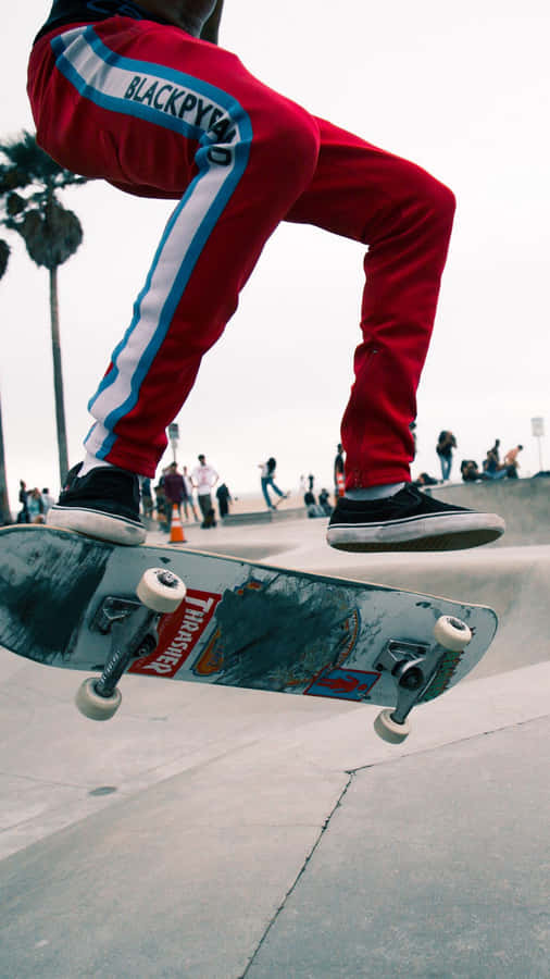 A Person Doing A Trick On A Skateboard Wallpaper