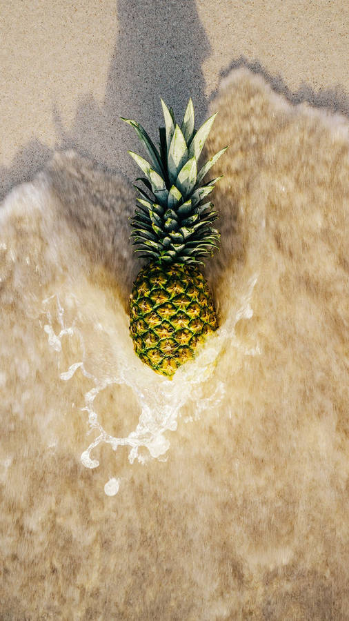 A Pineapple Being Bathed In Glistening Ocean Waves Wallpaper