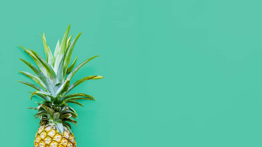 A Pineapple On A Turquoise Background Wallpaper