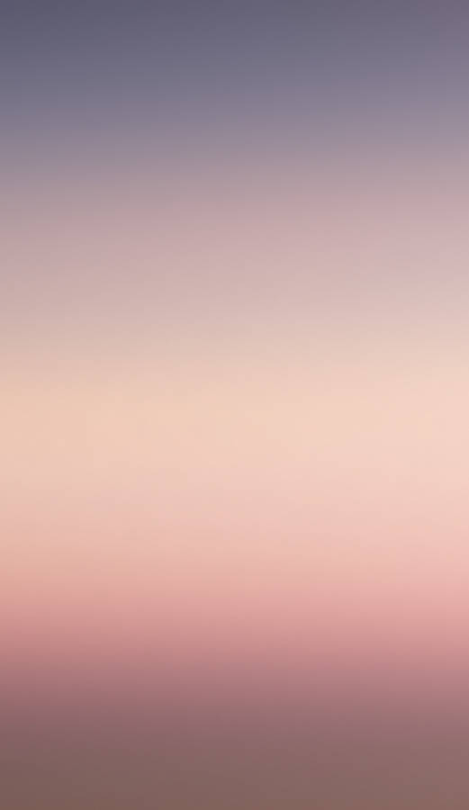 A Pink And Purple Sunset With A Plane In The Background Wallpaper