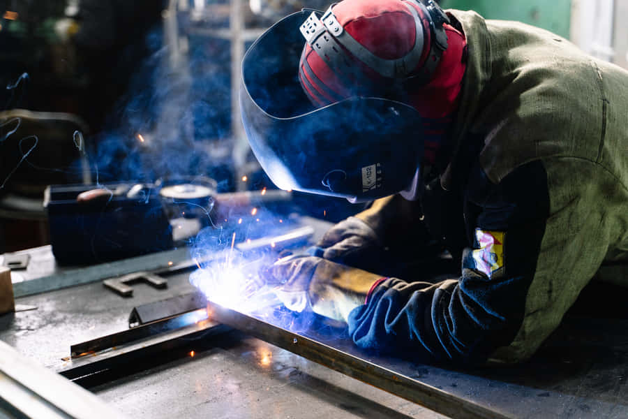 A Professional Welder Perfecting His Craft Wallpaper