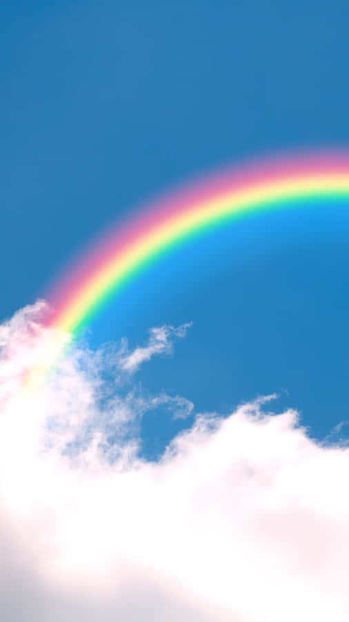 A Rainbow Is Seen In The Sky Above A Cloud Wallpaper