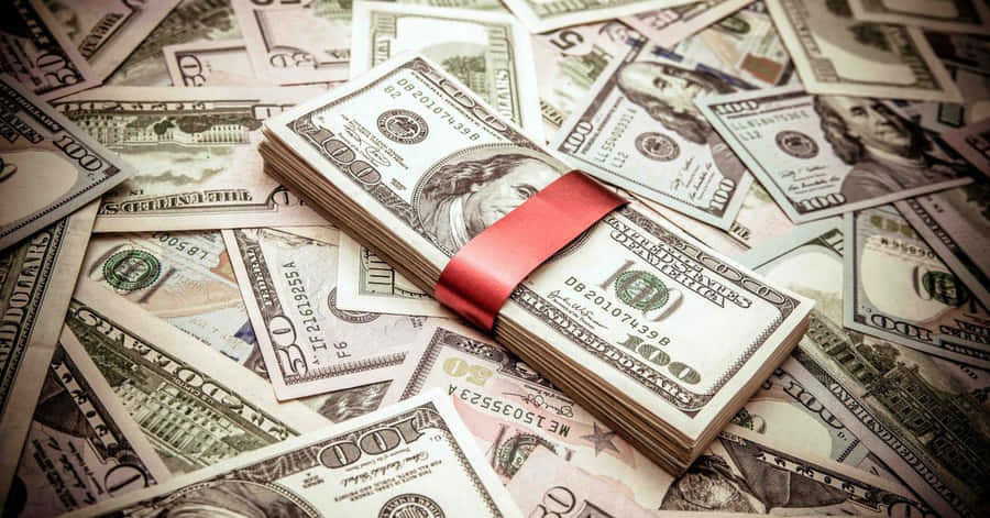 A Red Ribbon Is Tied Around A Pile Of Money Wallpaper