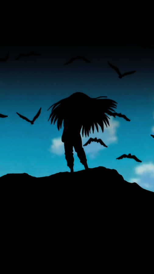 A Silhouette Of A Man With Long Hair Standing On A Hill Wallpaper