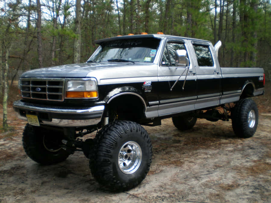 A Silver Truck Parked In The Woods Wallpaper