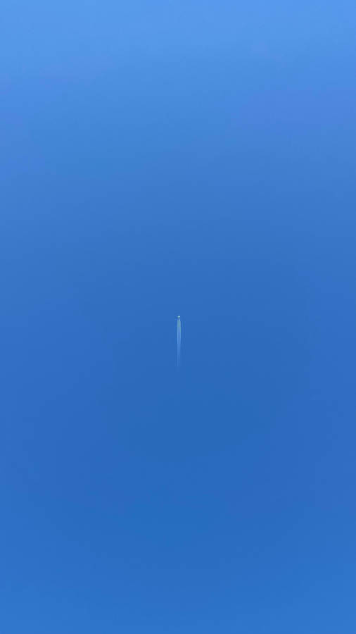 A Small Plane Trails A Ribbon Of Cloudy Vapor In The Sky Wallpaper