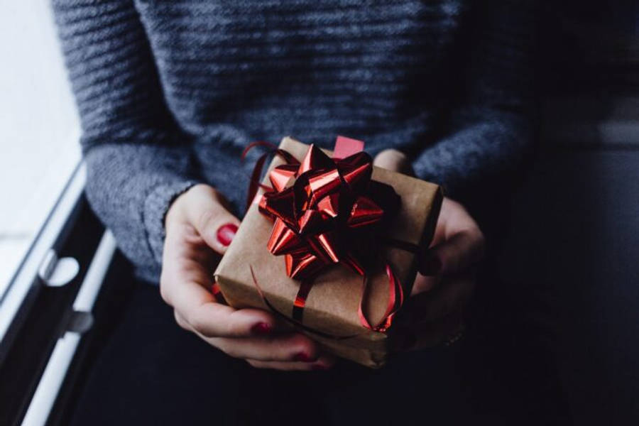 A Stack Of Elegantly Wrapped Christmas Presets Under The Tree Wallpaper