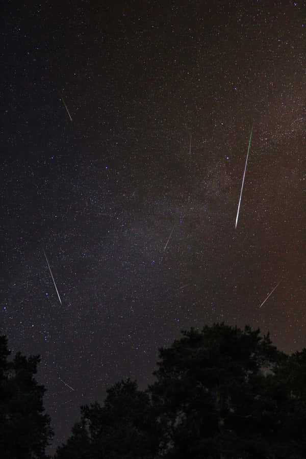 A Stunning Meteor Streaking Across The Night Sky Wallpaper