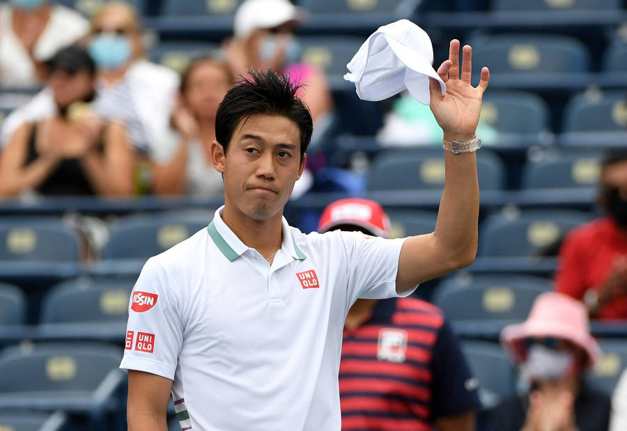 A Tennis Player Is Waving His Hat To The Crowd Wallpaper