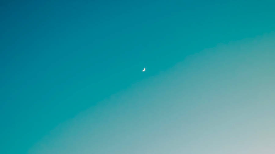 A Vibrant And Beautiful Ombre Sky Featuring A Crescent Moon Wallpaper
