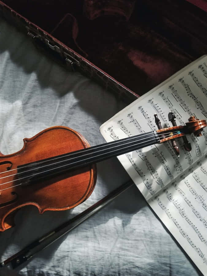 A Violin Hanging In The Studio Ready To Create Beautiful Music Wallpaper