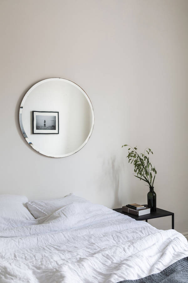 A White Bed With A Black Blanket Wallpaper