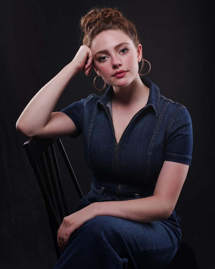 A Woman In A Blue Dress Sitting On A Chair Wallpaper