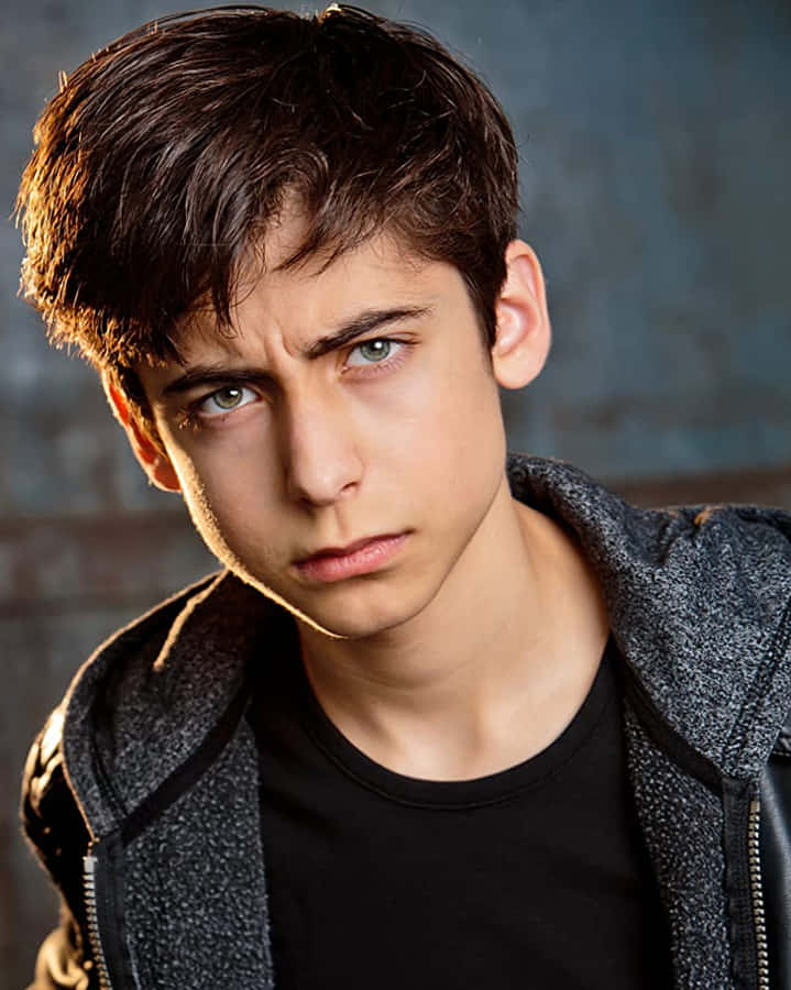 A Young Man In A Black Jacket And Black Pants Wallpaper