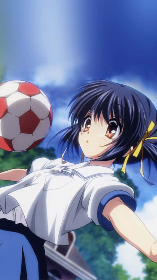 A Young Soccer Player Kicking The Ball Into The Goal Wallpaper