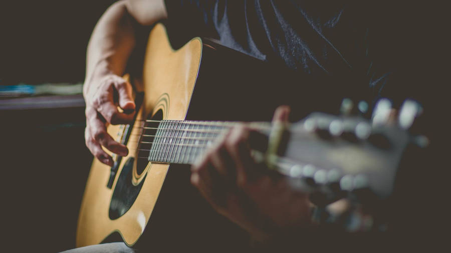 Acoustic Guitar Holding The Frets Wallpaper