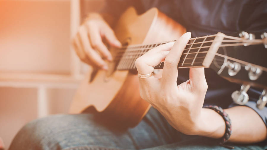 Acoustic Guitar On Lap Wallpaper