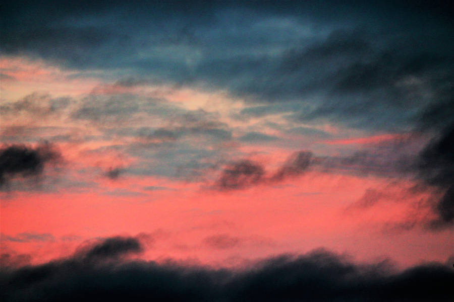 Admire The Beauty Of Ombre In A Stormy Red Sky Wallpaper
