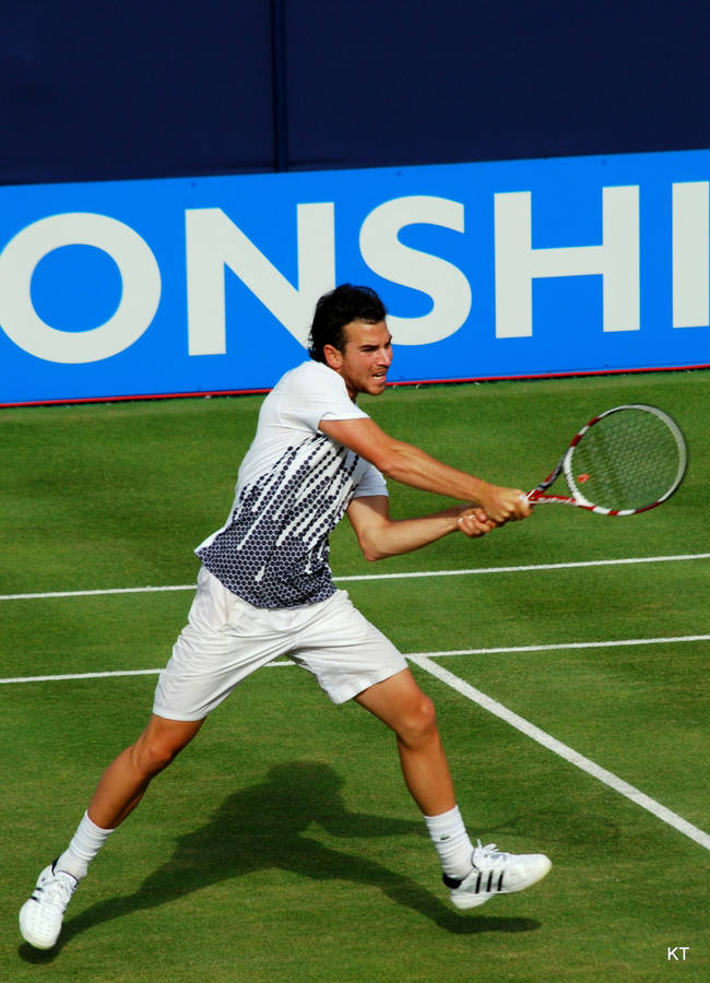 Adrian Mannarino Unleashing A Powerful Backhand Stroke In A Tennis Match Wallpaper