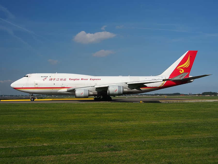 Aerial View Of A Jumbo Jet Soaring Through The Clouds. Wallpaper