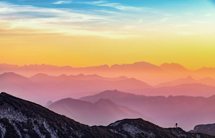 Aesthetic Sky Over Peaks Of Mountains Wallpaper