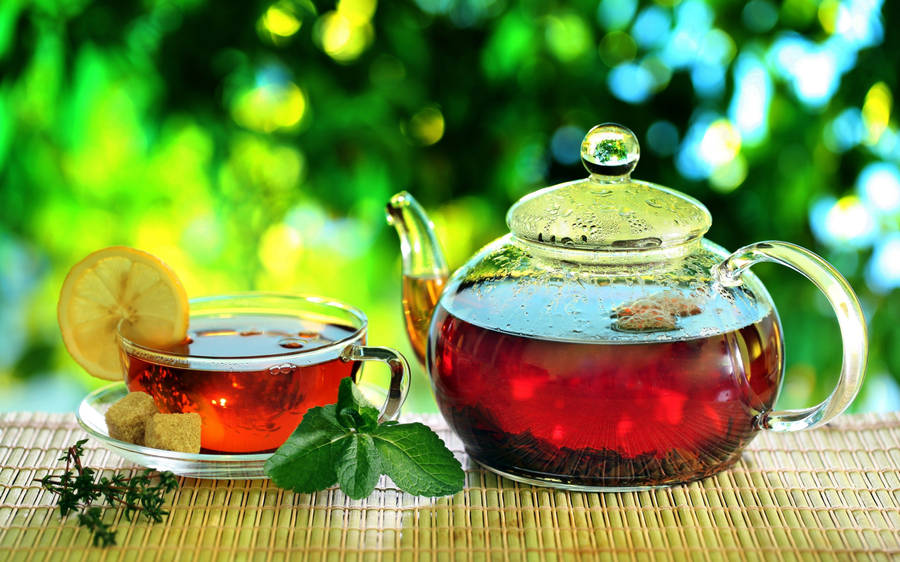 Aesthetic Tea Table Setting In A Garden Wallpaper