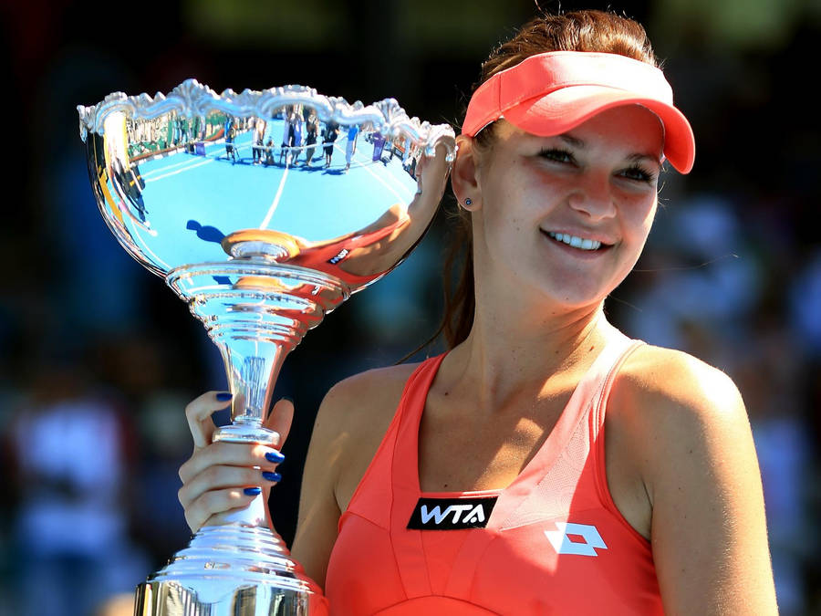 Agnieszka Radwanska Holding A Trophy Up Wallpaper