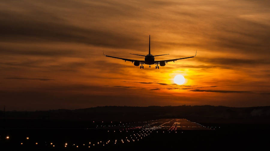 Aircraft Over The Runway At Dawn Wallpaper