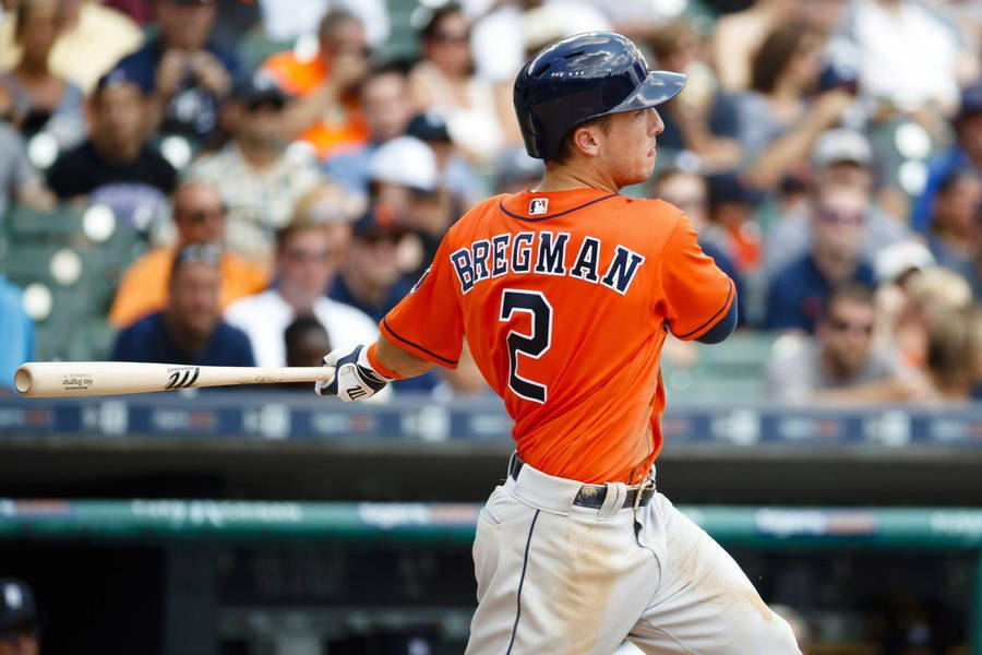 Alex Bregman Swinging Bat In Orange Jersey Wallpaper