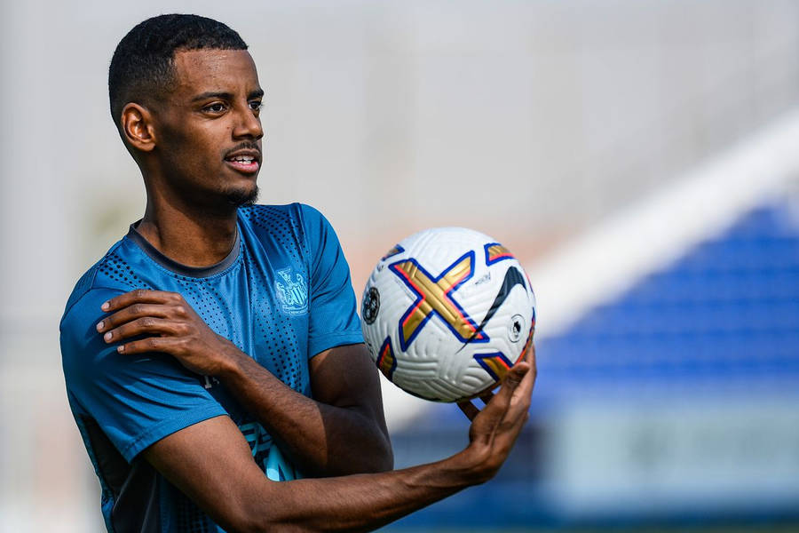 Alexander Isak Holding A Ball Wallpaper