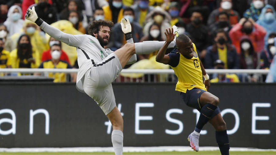 Alisson Becker Colliding With Enner Valencia Wallpaper