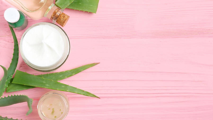 Aloe Vera Cream On Pink Table Wallpaper