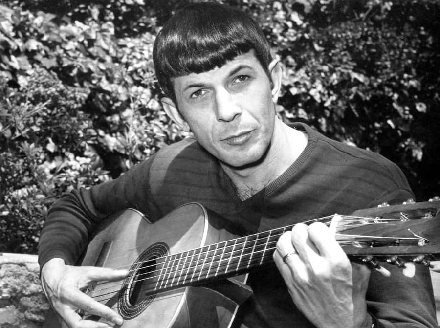 American Actor Leonard Nimoy Playing Guitar In 1967 Wallpaper