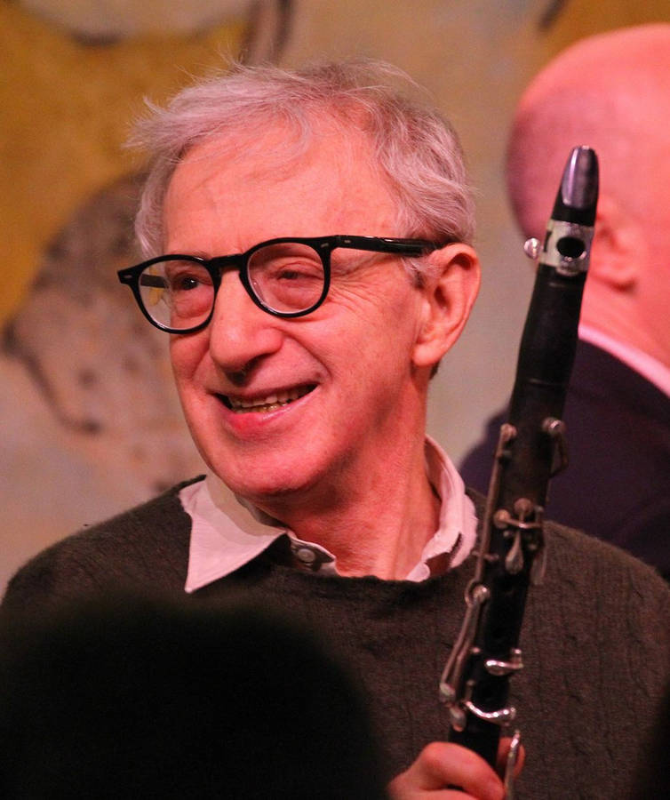 American Filmmaker Woody Allen Holding A Saxophone Wallpaper